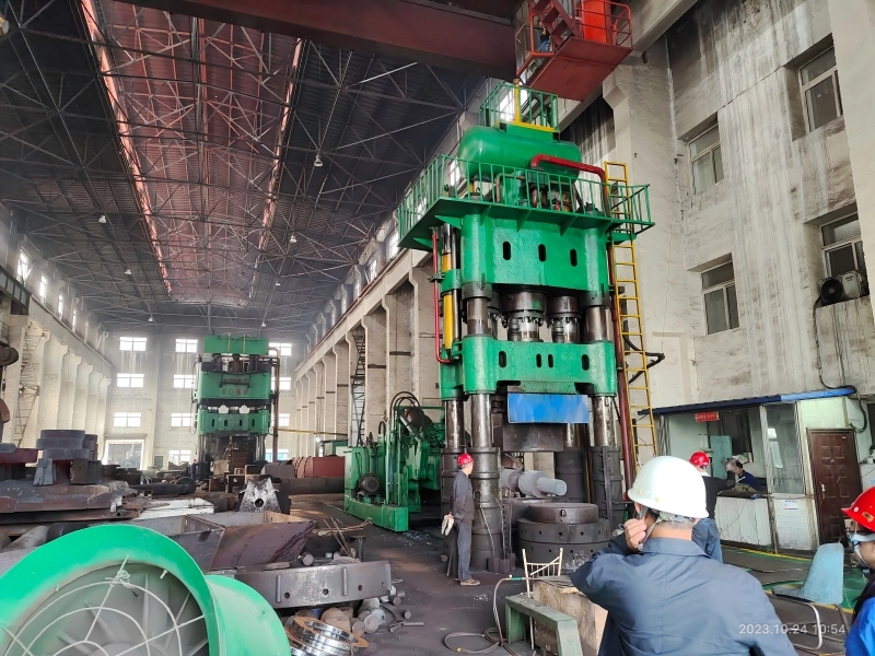 Metal forging process showing heated metal being shaped
